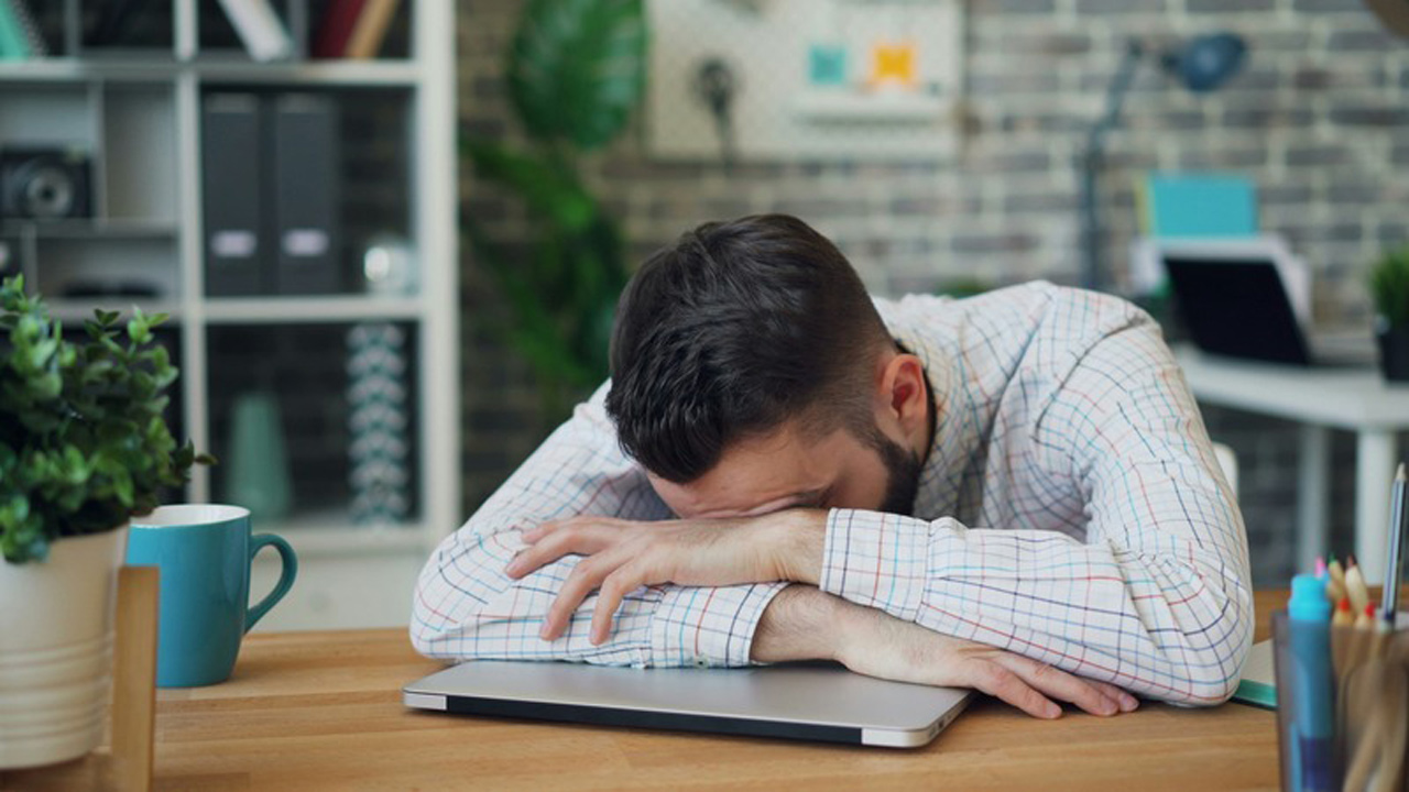 Employee experiencing burnout at his desk
